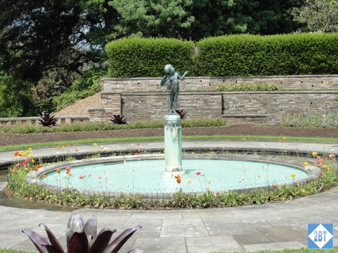 A fountain ringed by colorful flowers