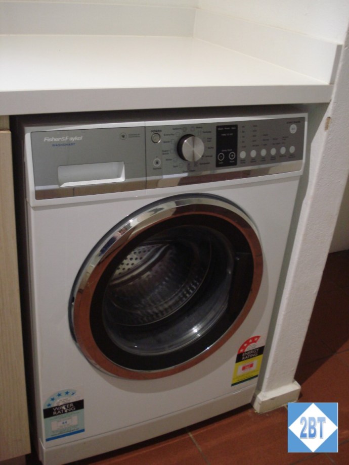 Washing machine is under the counter in the kitchen