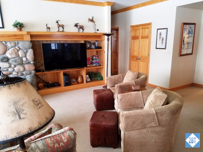 Massive TV with chairs for viewing. The door that's only half-visible leads to the 4th bathroom