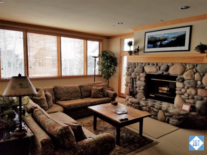 Giant sofa in front of the stone fireplace